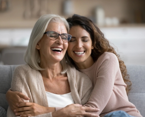 Daughter hugging her elderly mother diagnosed with one of the types of dementia