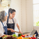 a young woman with elderly providing cooking with care