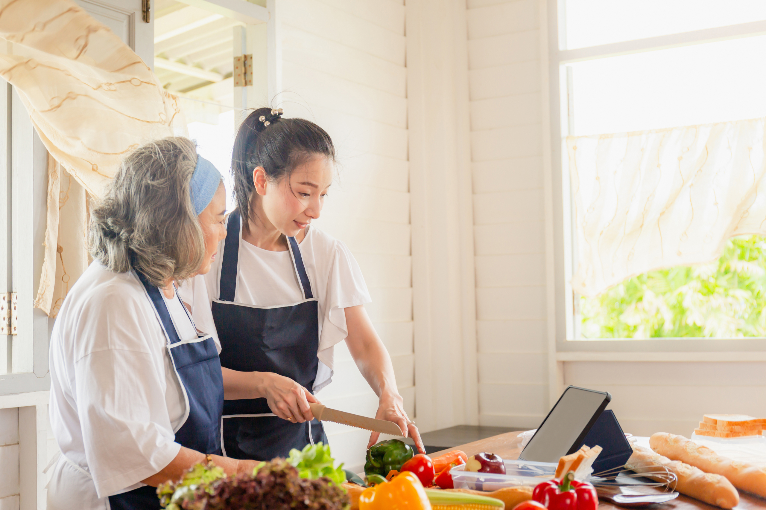 a young woman with elderly providing cooking with care a young woman with elderly providing cooking with care