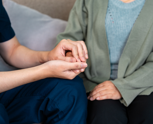 carer-holding-hand-late-stage-dementia-care.jpg