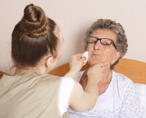 A family carer learning dementia awareness training techniques to support an elderly relative at home
