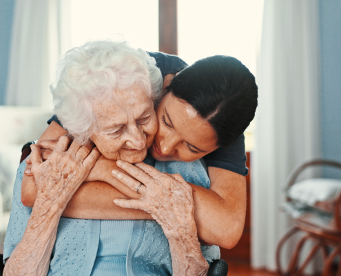 A trained carer providing dementia training support to an elderly person at home in Forton