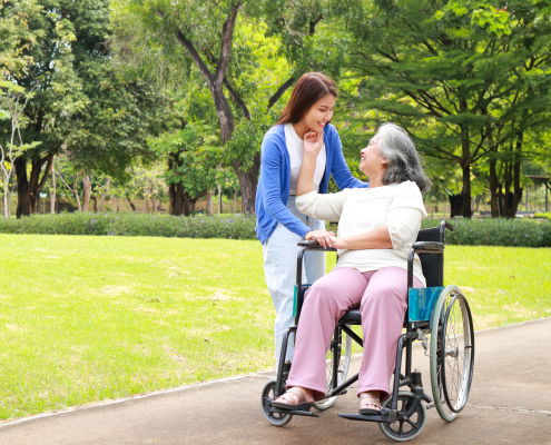 Carer and elderly woman sharing a warm conversation at home to support emotional well being