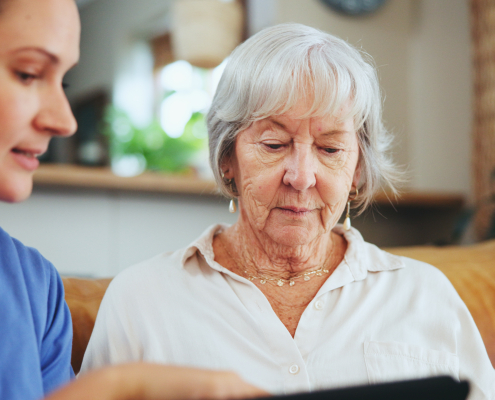 A carer and elderly woman sharing a conversation during a private companion visit at home in Lancashire, private companion for elderly near me.